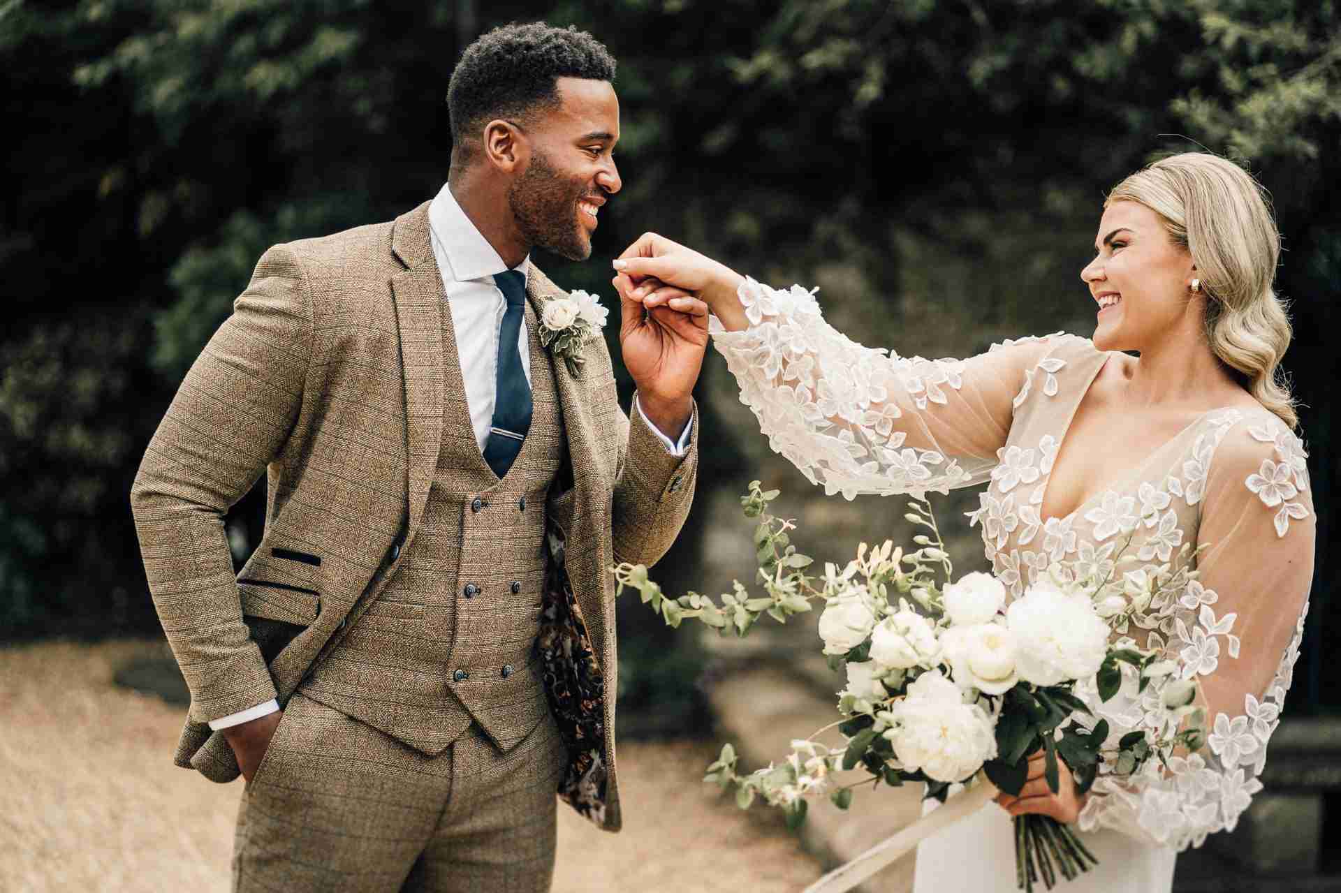 PORTFOLIO 32 groom holds brides hand during wedding first look