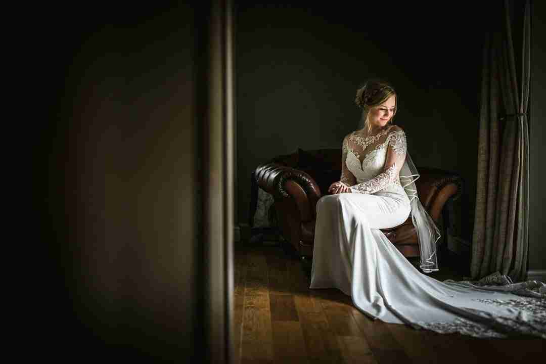 PORTFOLIO 44 bride sat on chair near window light