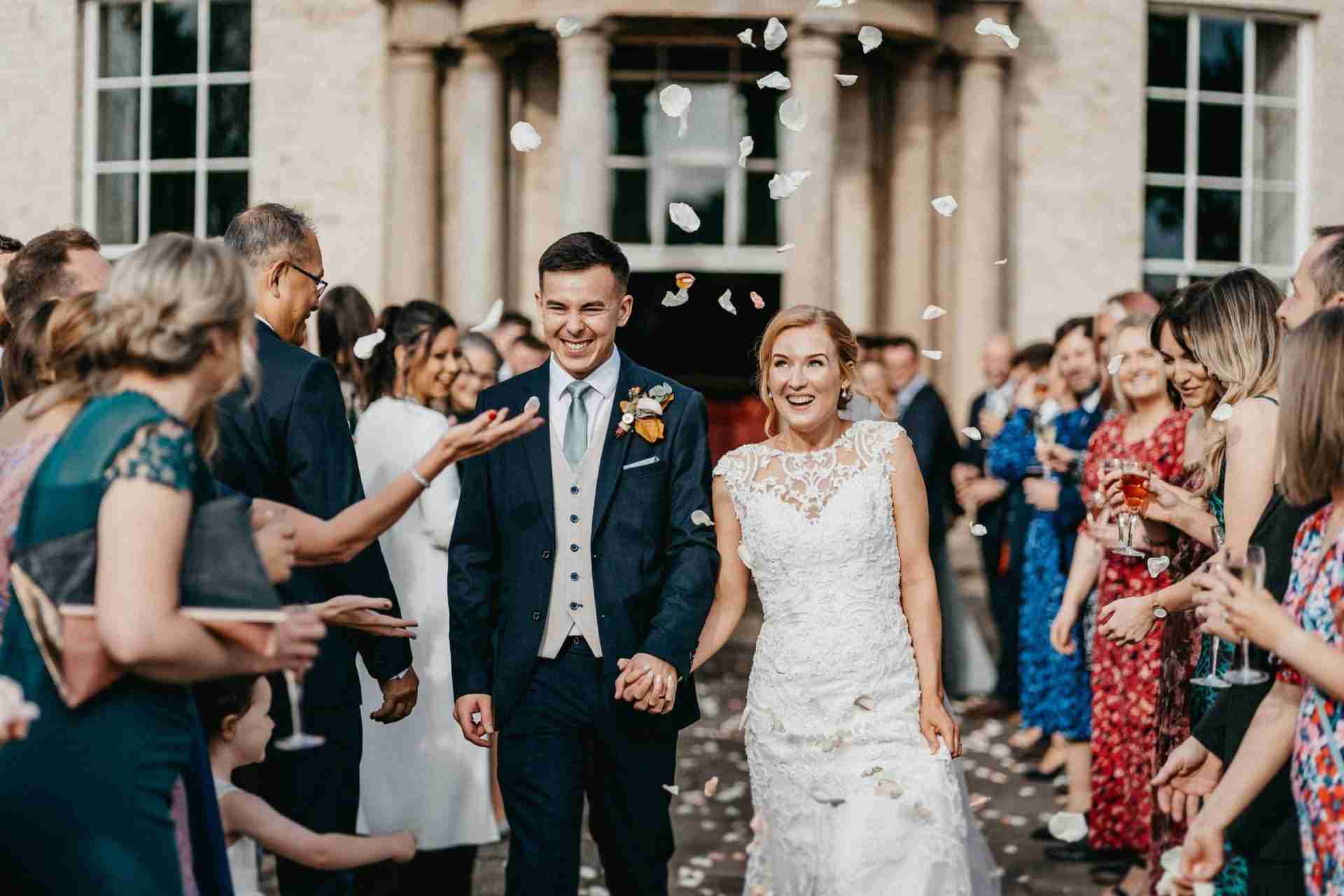 STUBTON HALL | Amelia & Tom 11 Bride and groom having confetti thrown at them at Stubton Hall wedding venue