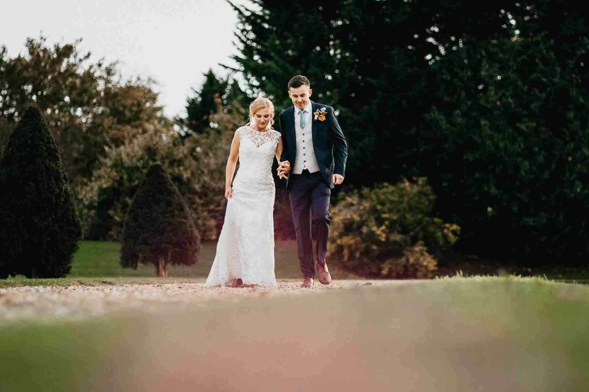 STUBTON HALL | Amelia & Tom 14 Bride and groom walking along at Stubton Hall wedding venue