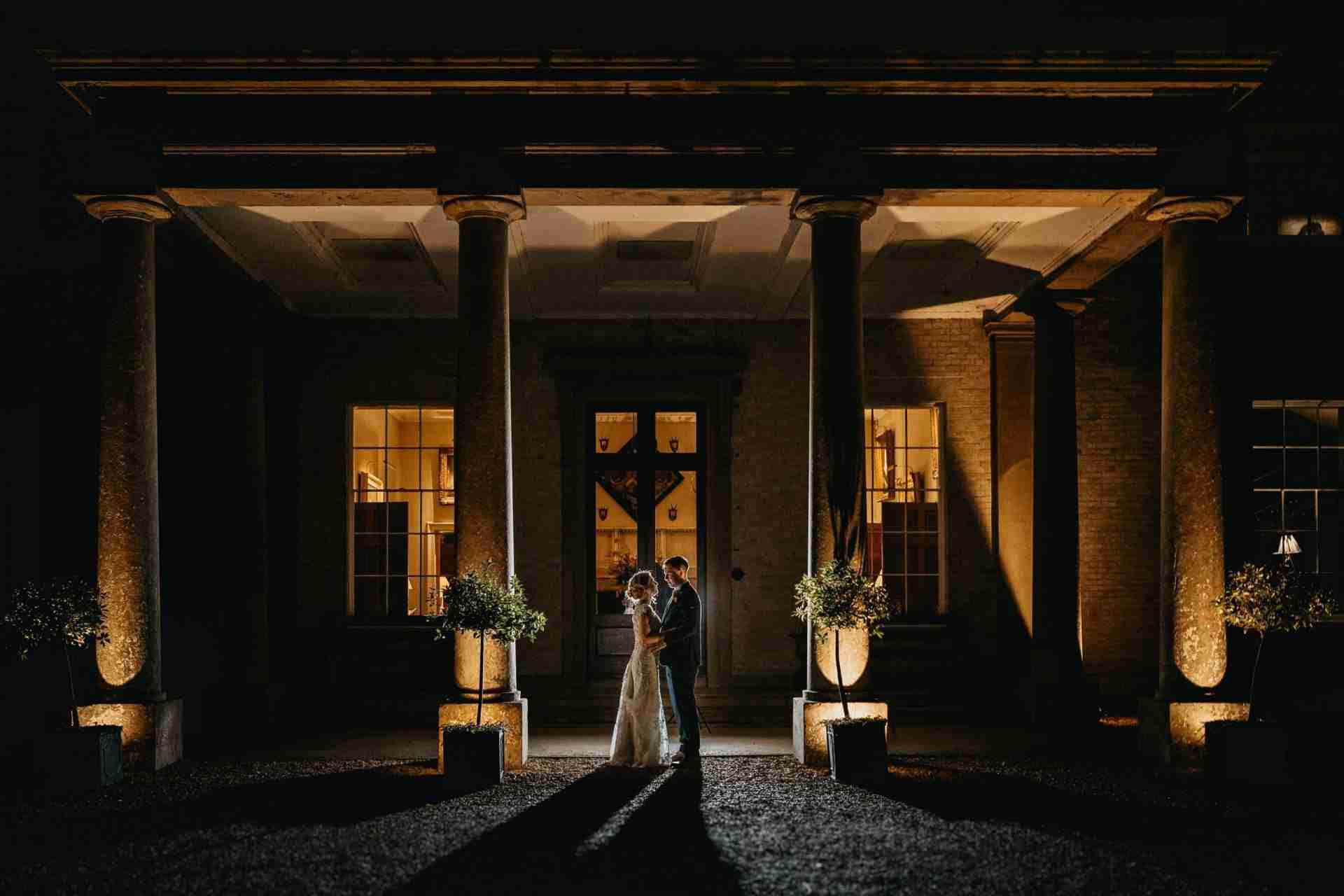 STUBTON HALL | Amelia & Tom 31 Bride and groom stood outside the main entrance of Stubton Hall wedding venue