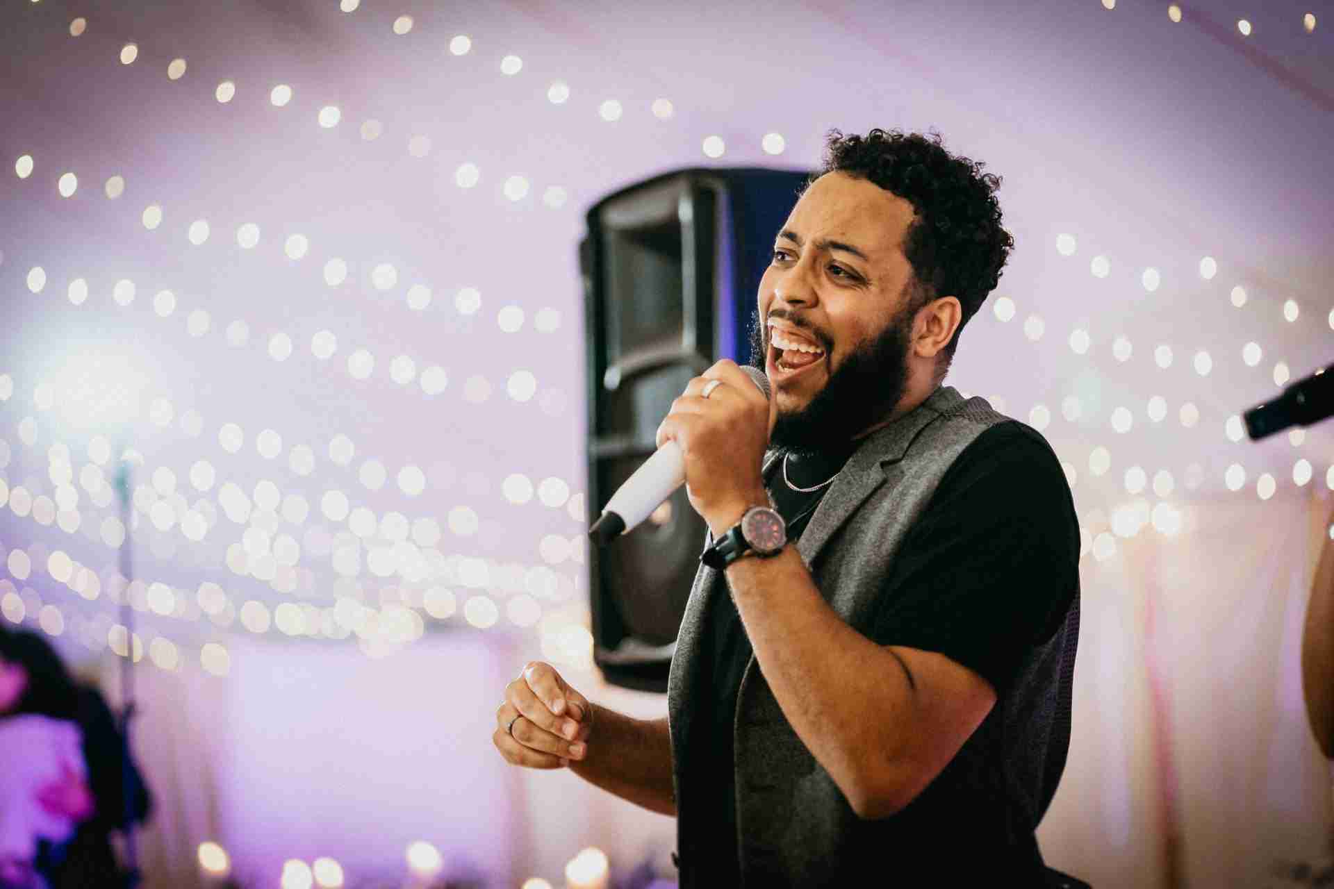 HOME 32 a man singing into a microphone