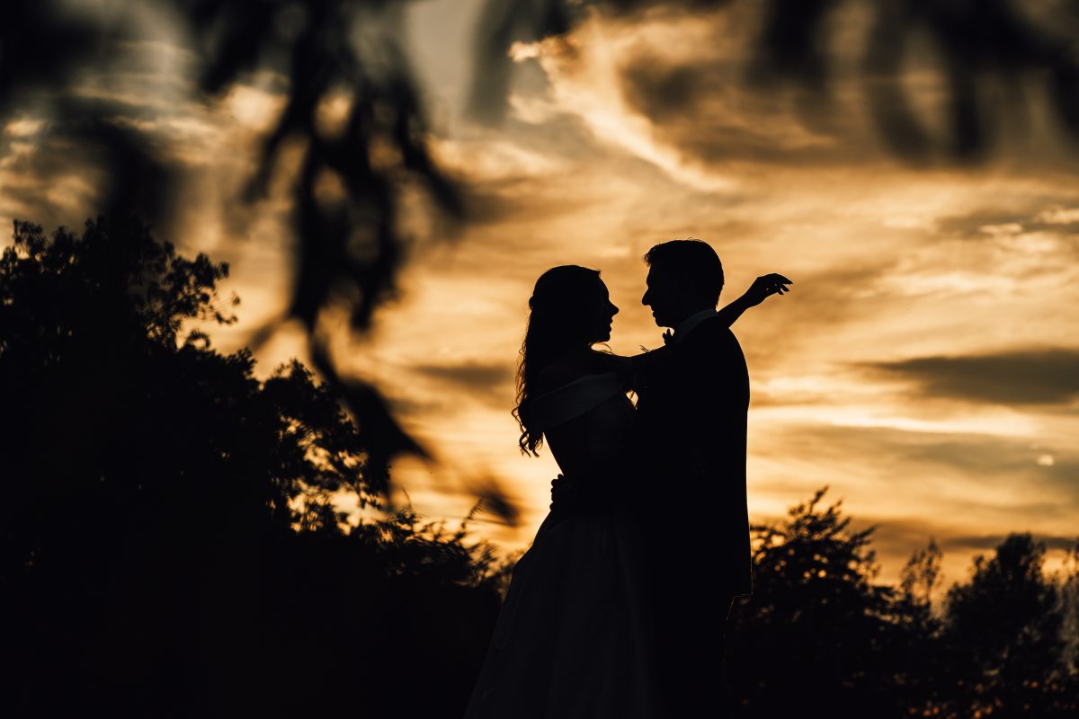 PORTFOLIO 103 a silhouette of a man and woman dancing at twilight wedding reception