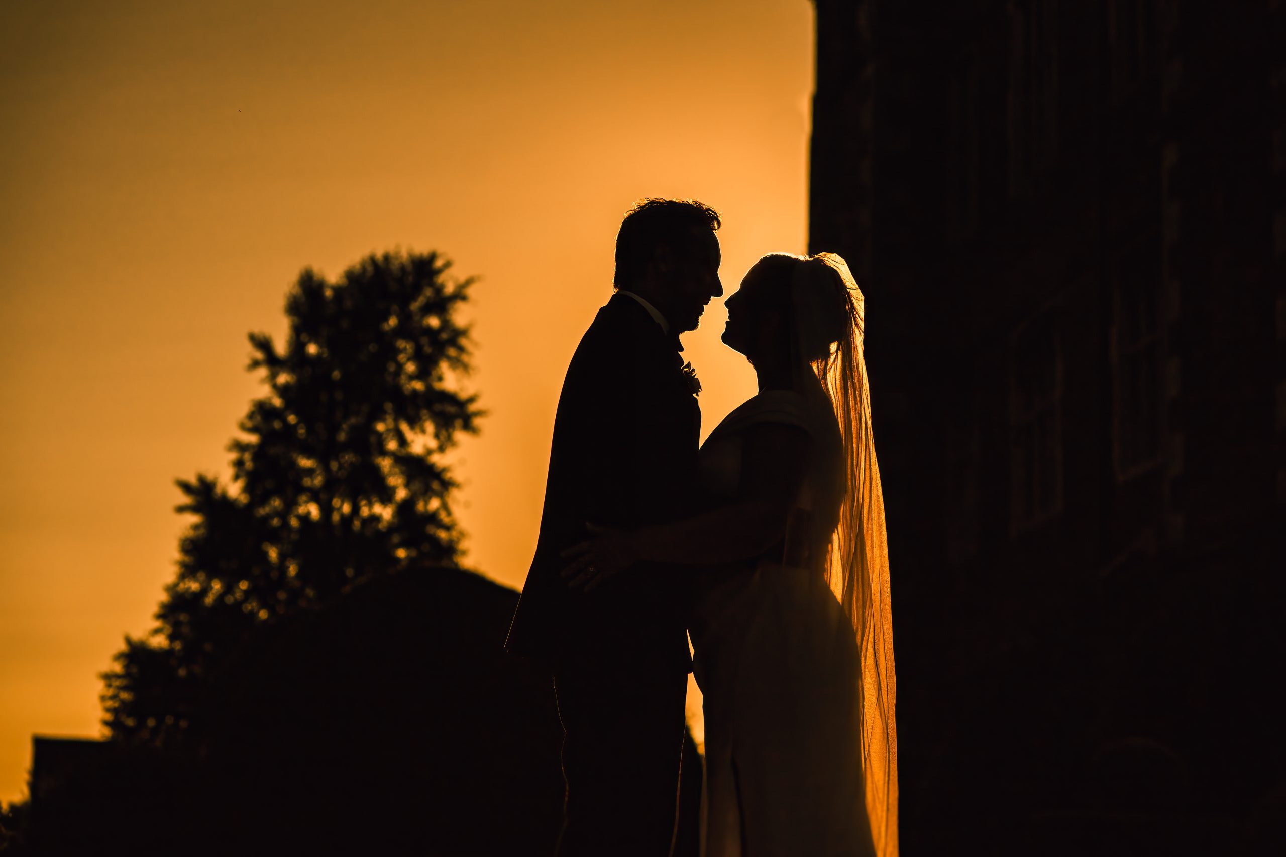 PORTFOLIO 67 a silhouette of a man and woman in a wedding dress