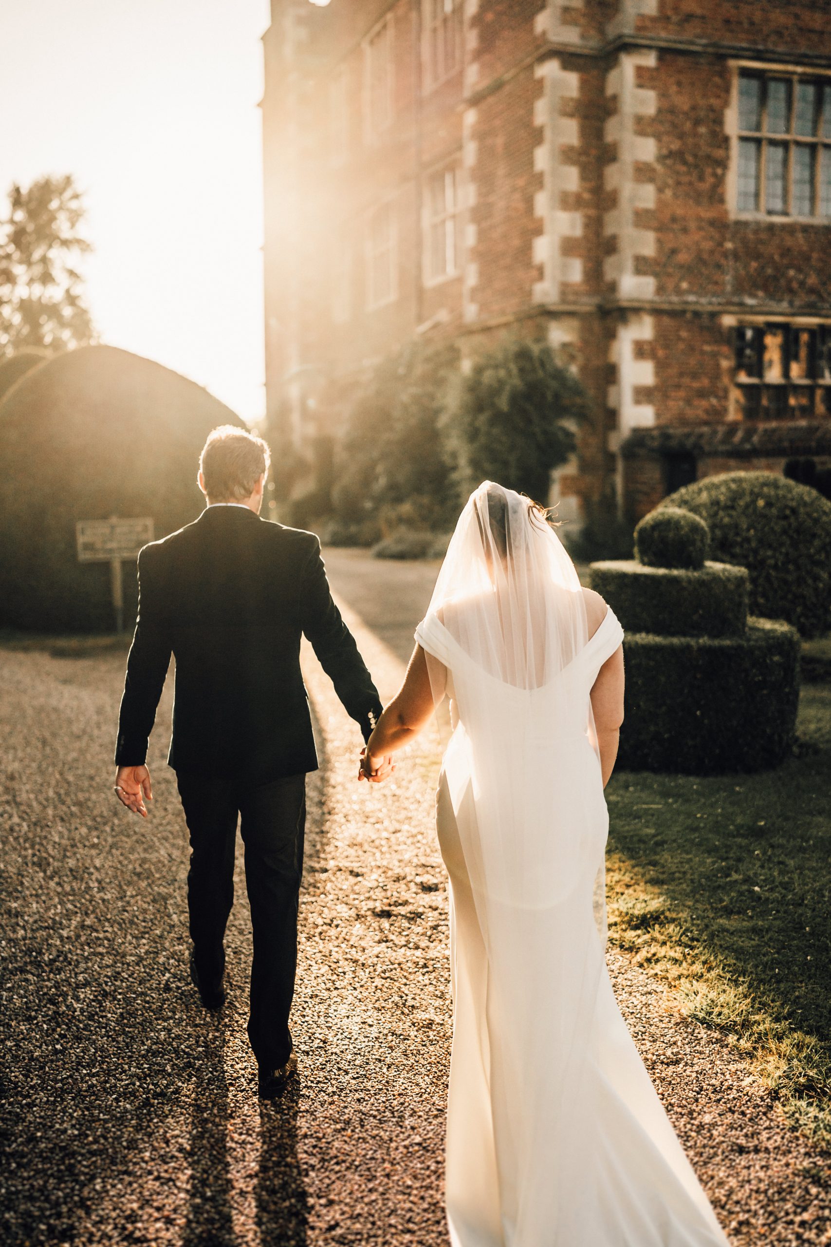 PORTFOLIO 68 a man and woman holding hands and walking down a path