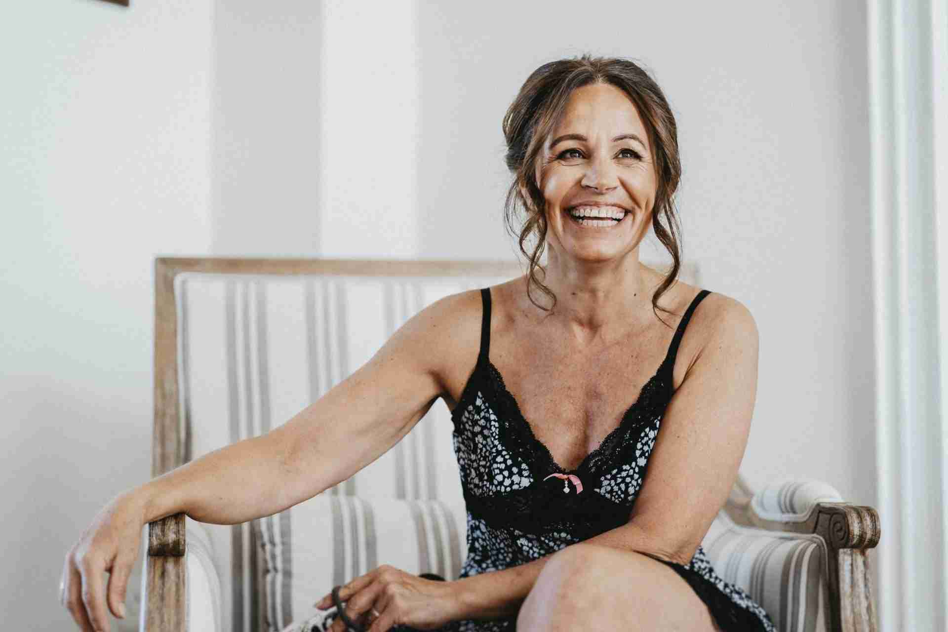PORTFOLIO 64 a woman smiling in a black and white dress