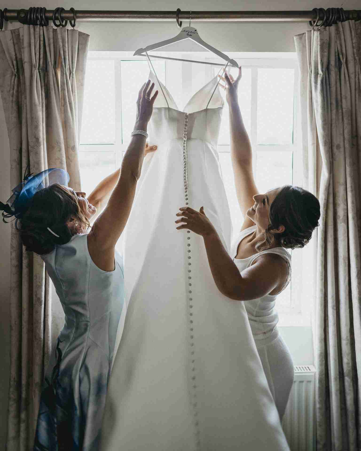 VENUE GUIDE | Doddington Hall 15 two women holding a dress